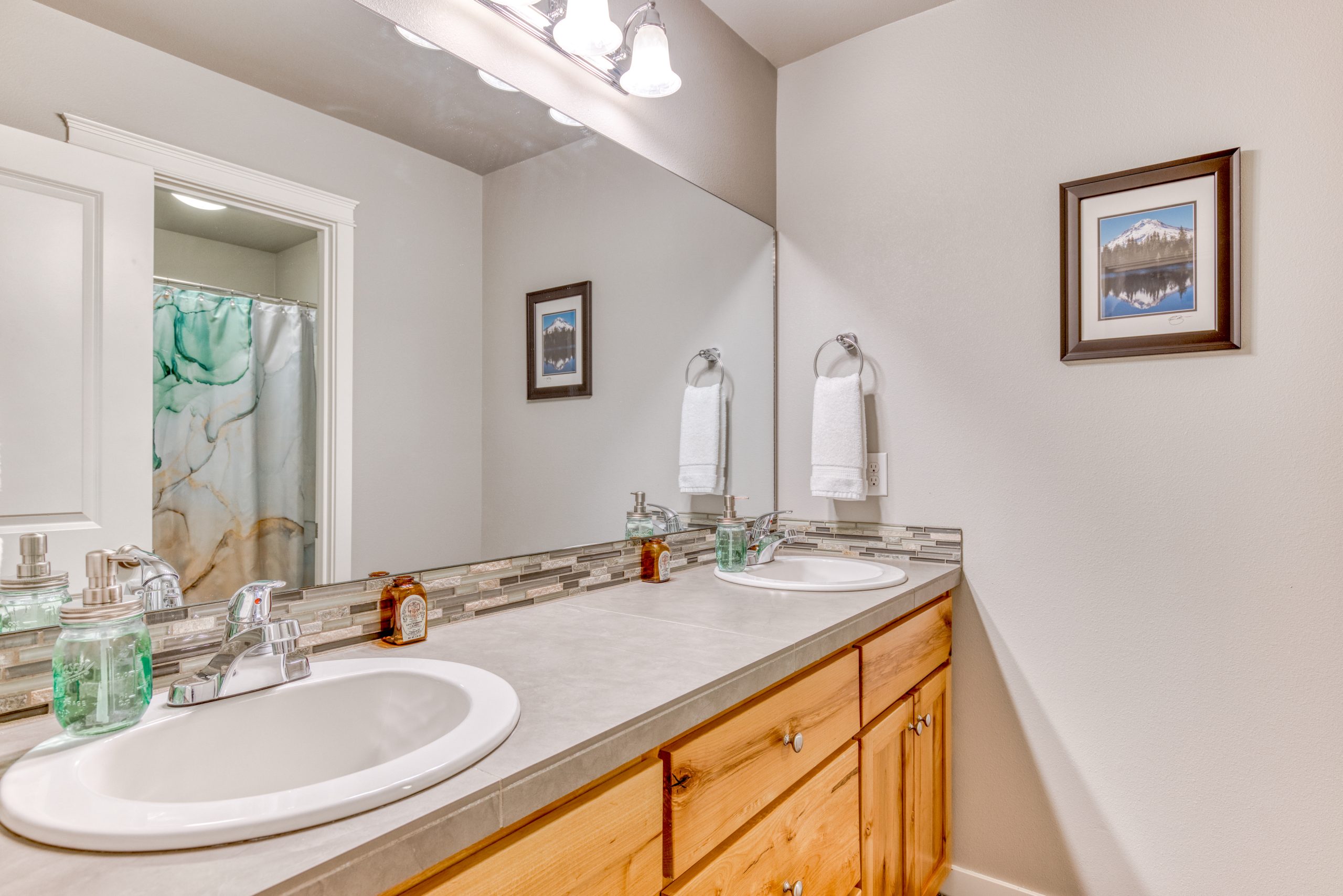Dual sinks with a door to close off the shower and toilet for privacy.