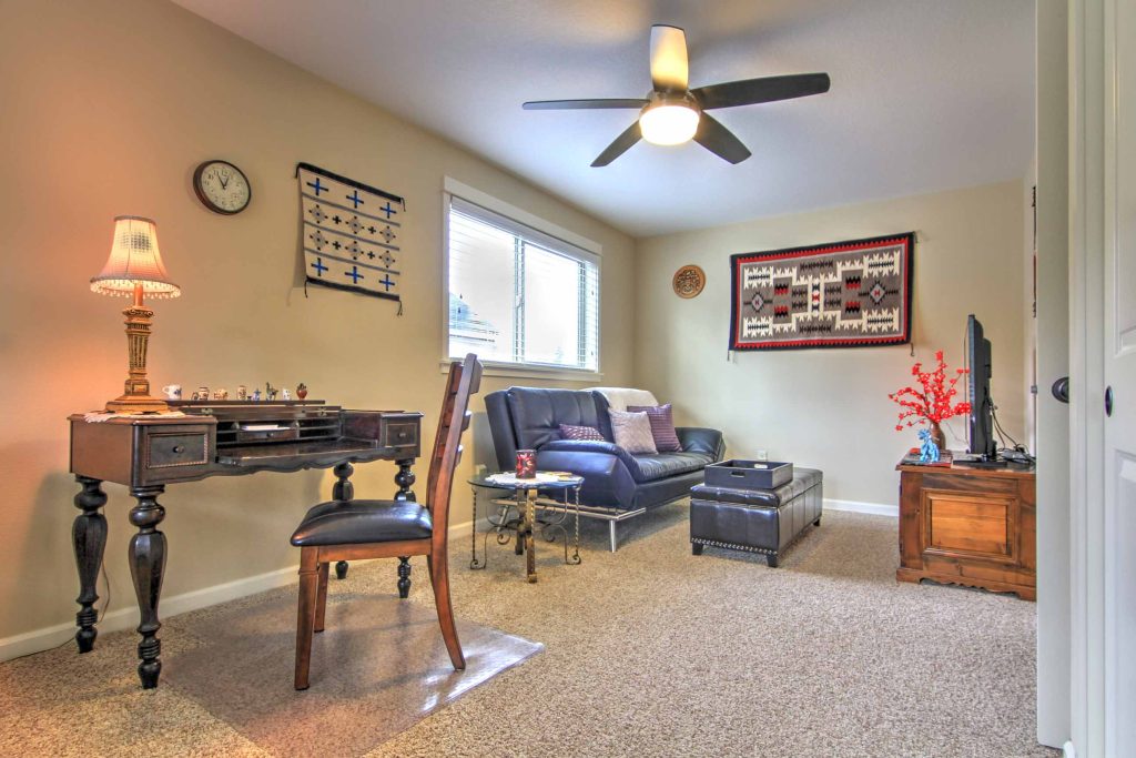 Antique 1925 spinet desk and hand-woven Native American rugs.