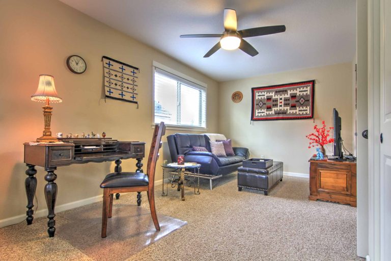 Antique 1925 spinet desk and hand-woven Native American rugs.