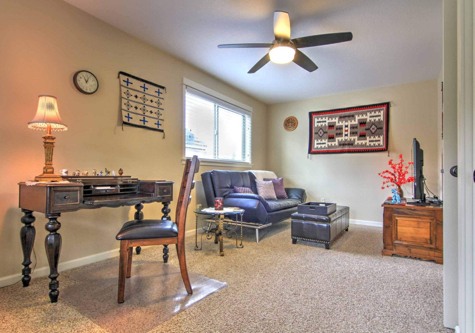 Antique 1925 spinet desk and hand-woven Native American rugs.